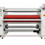 Front view of a used Crest MLC-1600 4-roll laminator with feed-in table and unwind/wind-up shafts