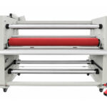 Rear view of a used Crest MLC-1600 4-roll laminator with unwind/wind-up shafts and foot pedal
